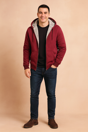 Men's zip-up hoodie in deep burgundy with front kangaroo pockets, adjustable drawstring hood, and soft gray fleece lining—perfect for warm, casual winter layering.