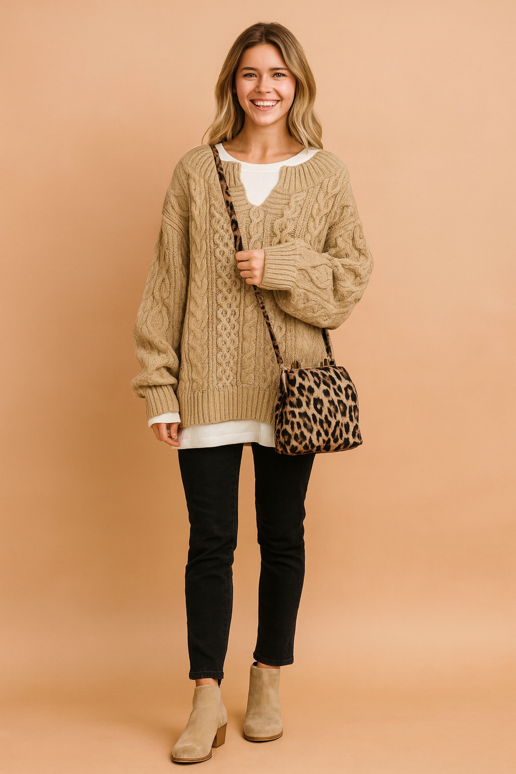 Oversized sweater with classic cable pattern, paired with a white inner shirt, slim black pants, white sneakers, and a leopard-print shoulder bag