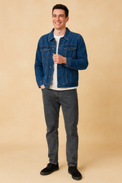 Classic blue denim jacket with button-up front, flap chest pockets, and a structured cut, paired with black pants for a timeless casual look.