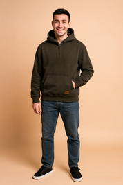 Dark charcoal half-zip hoodie with front kangaroo pocket, ribbed cuffs, and hem, paired with casual jeans for a relaxed streetwear look.