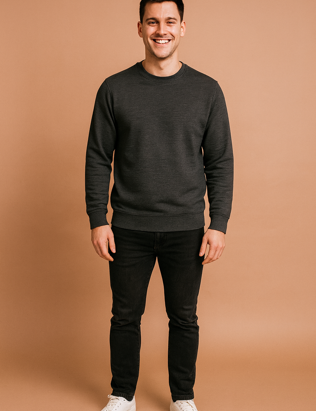 Men’s dark gray crewneck sweatshirt with ribbed cuffs and hem, styled with slim-fit black jeans and classic white sneakers.