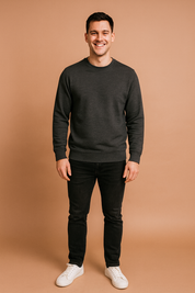 Men’s dark gray crewneck sweatshirt with ribbed cuffs and hem, styled with slim-fit black jeans and classic white sneakers.