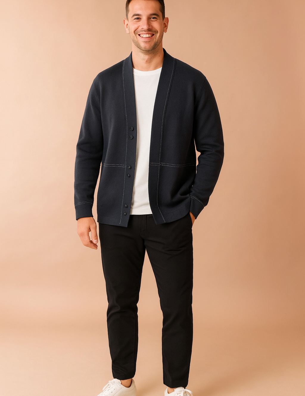 Dark gray open-front cardigan with white stitched detailing, styled over a white T-shirt, slim black trousers, and white sneakers for a modern casual look.