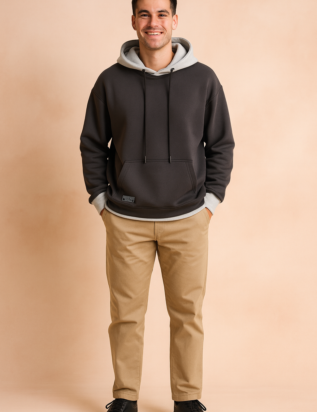 Men’s dark grey hoodie with light grey hood lining and drawstrings, featuring a relaxed fit and ribbed cuffs for modern streetwear style.