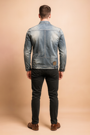 Men’s distressed denim jacket in faded grey wash with visible seam details and worn patches, long sleeves, and a straight back cut for casual streetwear styling.