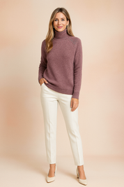Dusty mauve fitted knit turtleneck sweater with ribbed cuffs and hem, styled with ivory tailored trousers and matching heels.