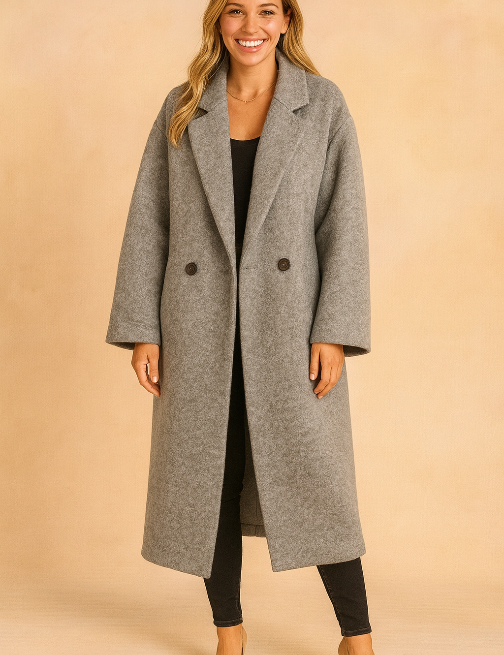 Long gray oversized double-breasted coat with wide lapels, paired with black slim-fit pants and beige heels.
