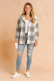 Gray and white plaid hooded jacket with button closure and subtle mustard accents, styled with ripped jeans for a casual look.