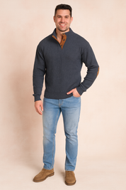 Gray ribbed pullover sweater with brown button placket and suede elbow patches, paired with light blue slim-fit jeans and brown suede shoes.