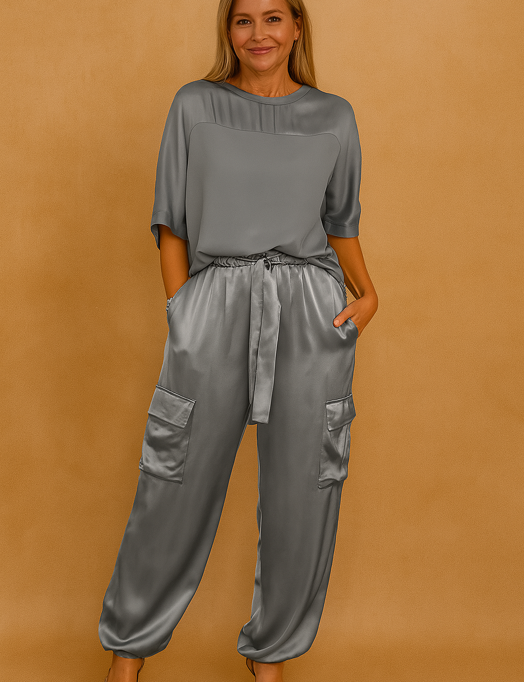 Satin two-piece set featuring a loose-fit short-sleeve top and high-waisted drawstring cargo pants with flap pockets, styled with leopard-print stiletto heels for a sleek, elevated look.