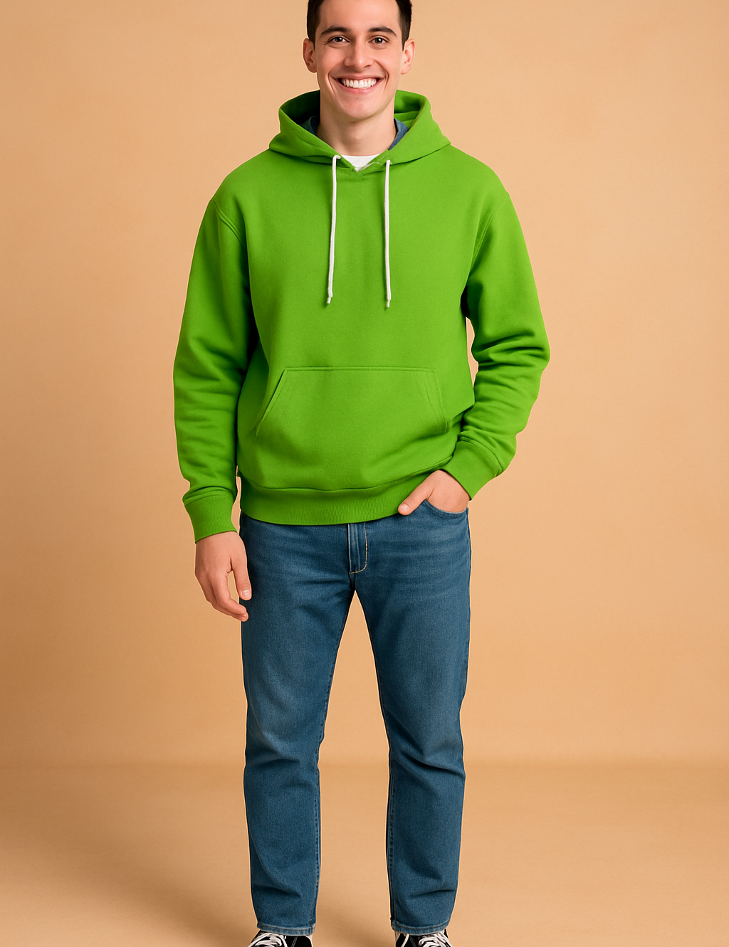 Green hoodie with front kangaroo pocket and white drawstrings, paired with blue jeans and black sneakers