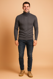 Slim-fit grey ribbed turtleneck sweater for men with vertical textured pattern, styled with dark jeans and beige lace-up boots.