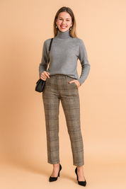 Elegant grey turtleneck sweater with a soft knit texture, paired with high-waisted plaid trousers and black pumps, styled with a quilted crossbody bag for a chic and versatile look.