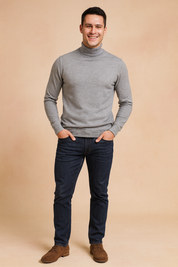 Heather gray men’s turtleneck sweater with ribbed cuffs and hem, paired with slim-fit dark blue jeans and brown suede shoes, delivering a modern and versatile casual style.