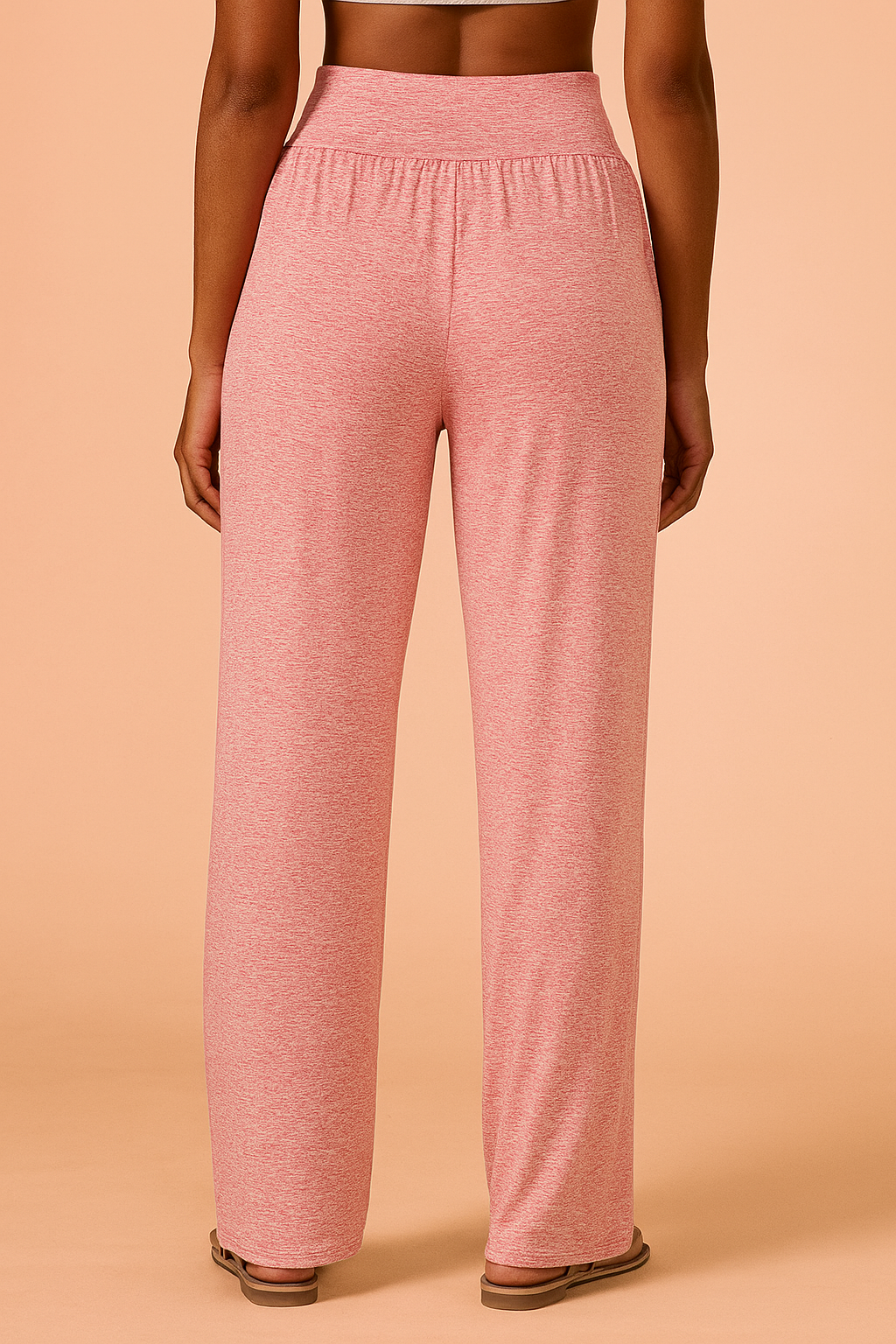  Heathered pink wide-leg lounge pants with a high waistband and side pockets, styled with flat sandals for a relaxed, cozy look.