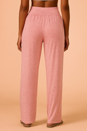  Heathered pink wide-leg lounge pants with a high waistband and side pockets, styled with flat sandals for a relaxed, cozy look.