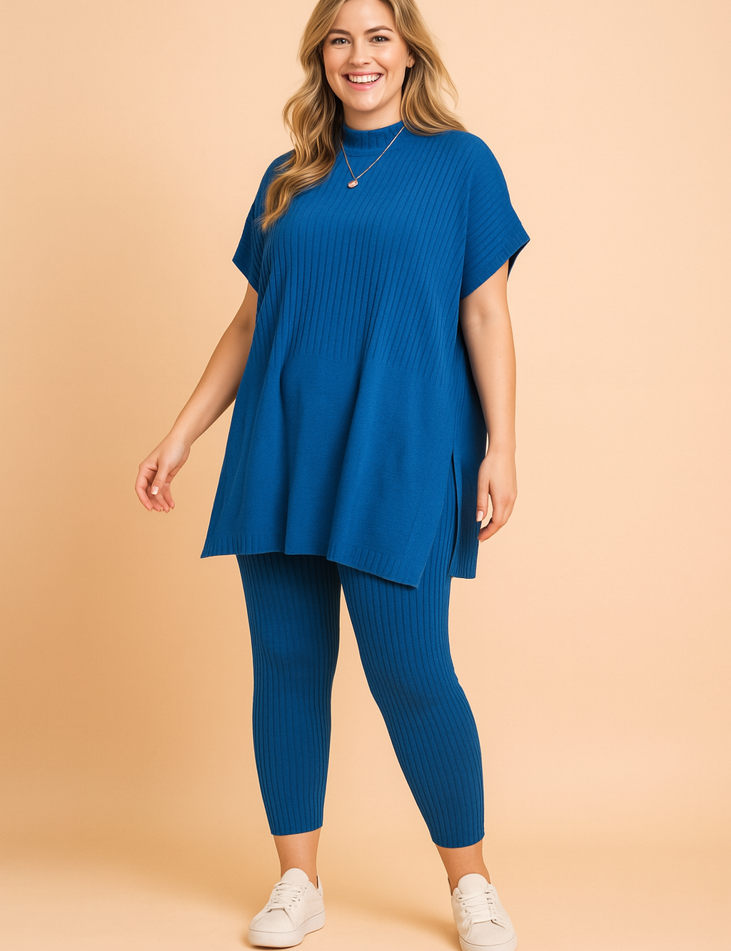 Ribbed knit cobalt blue co-ord set featuring a loose-fitting short-sleeve top with side slits and matching ankle-length fitted leggings, styled with white sneakers.