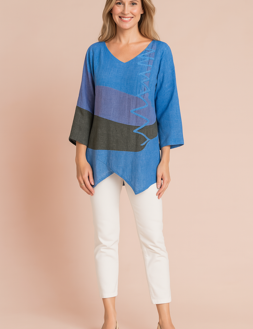 Color-blocked tunic blouse featuring wide three-quarter sleeves, an asymmetrical hem, and bold horizontal bands in denim blue, muted lavender, and charcoal black, accented with a crisscross stitch detail on the front.