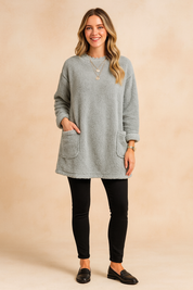 Long oversized sweater with a fluffy, plush texture, featuring two practical front pockets and a simple, comfortable fit.
