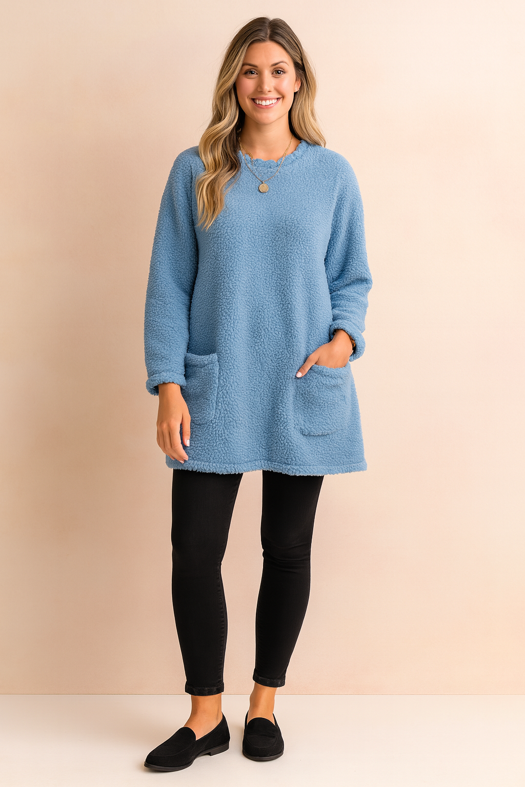 Long oversized sweater with a fluffy, plush texture, featuring two practical front pockets and a simple, comfortable fit.