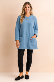 Long oversized sweater with a fluffy, plush texture, featuring two practical front pockets and a simple, comfortable fit.