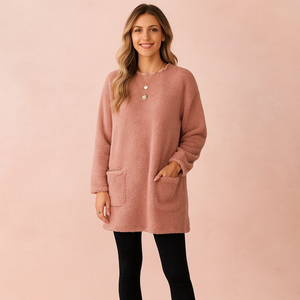 Long oversized sweater with a fluffy, plush texture, featuring two practical front pockets and a simple, comfortable fit.
