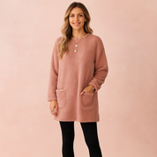 Long oversized sweater with a fluffy, plush texture, featuring two practical front pockets and a simple, comfortable fit.