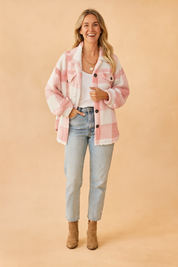 Pink and white plaid sherpa shacket with front flap pockets, black buttons, and cozy fleece texture, styled over a white scoop-neck tee and high-rise light wash jeans
