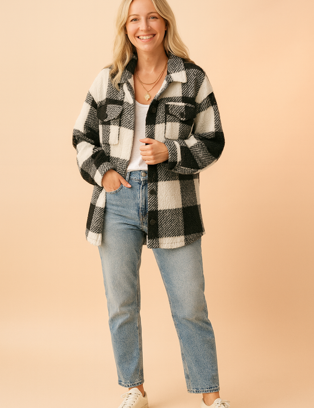 Black and white sherpa plaid button-up jacket with chest pockets, paired with a white tank top and high-waisted light wash jeans.