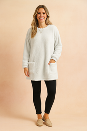 Long oversized sweater with a fluffy, plush texture, featuring two practical front pockets and a simple, comfortable fit.
