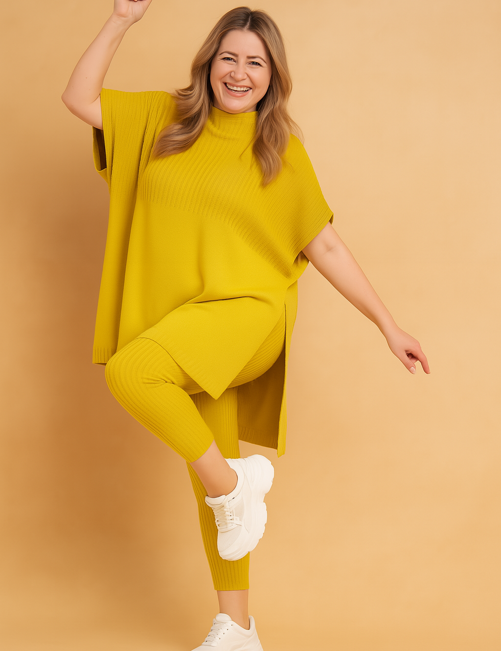 Two-piece ribbed knit coord set featuring a loose-fit oversized tunic with side slits and matching fitted ankle-length leggings, styled with chunky white sneakers for a cozy casual look.