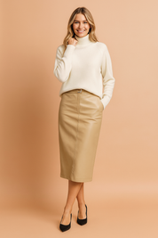 Ivory knit turtleneck sweater with ribbed collar and hem, styled with a beige faux leather pencil skirt and pointed black pumps