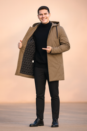 Men's long parka coat in khaki brown with quilted black interior lining, hooded design, full-length zip closure, and sleek tailored cut for winter wear.