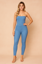 High-waisted light blue jeggings with faux pocket details, slim fit cut, and ankle-length hem, styled with clear heeled sandals for a sleek modern look.