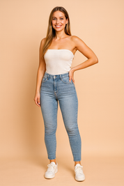 Light blue high-waisted skinny jeans with a faded wash design, paired with classic white sneakers