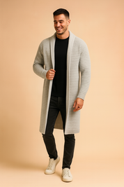 Long light grey knit cardigan with ribbed texture, open-front design, ribbed cuffs, and a sleek modern fit paired with a black shirt and dark jeans.