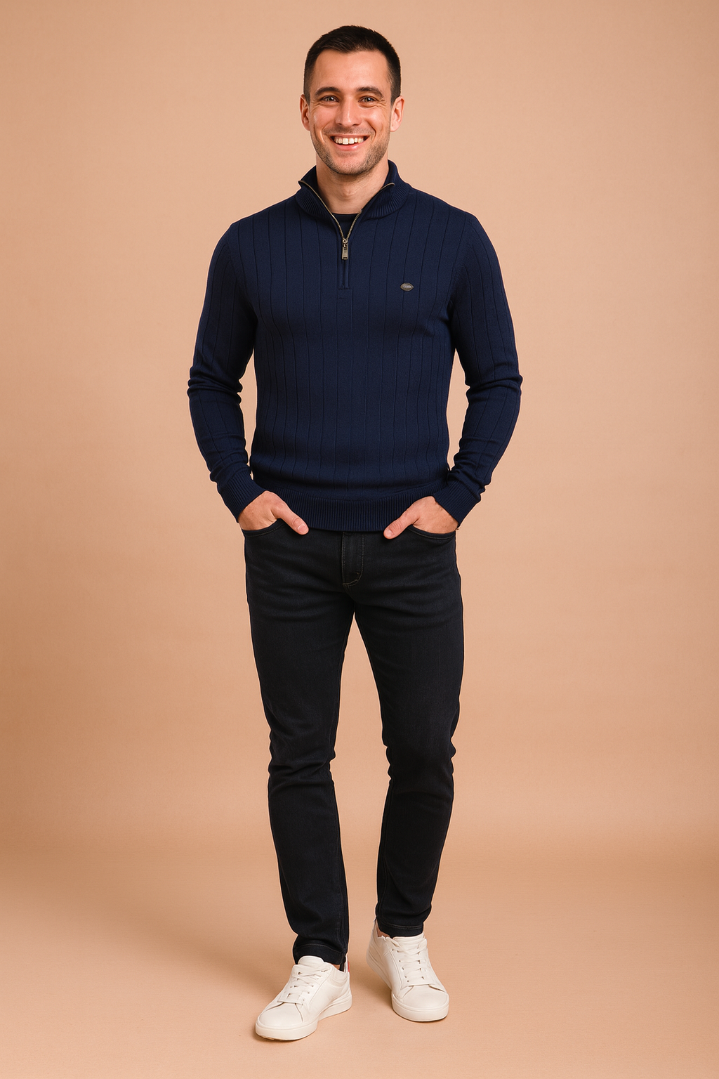 Men’s navy ribbed quarter-zip sweater with vertical textured patterns, styled with slim-fit dark jeans and white sneakers.