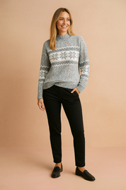 Blue, white, and pink Nordic snowflake patterned crewneck sweater with ribbed hem and cuffs, paired with slim-fit black trousers and black loafers.