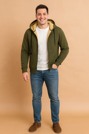 Olive green sherpa-lined zip hoodie with drawstrings, front pockets, and cozy cream fleece interior, styled with jeans and brown suede shoes for a casual look.