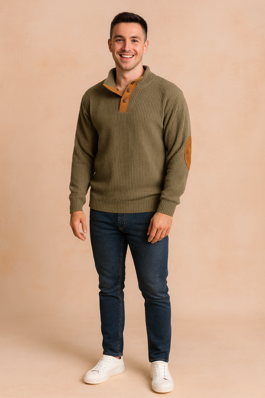 Men’s olive green ribbed pullover sweater with buttoned placket and brown suede elbow patches, styled with dark blue jeans and white sneakers.