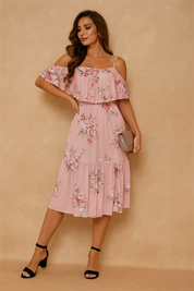 Pink off-shoulder floral midi dress featuring spaghetti straps, tiered ruffle layers, and a soft rose pattern in ivory, blush, and burgundy, styled with a taupe clutch and black block heels.