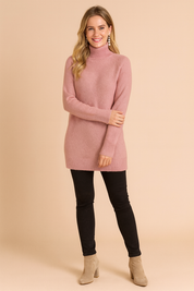 Pink ribbed knit turtleneck sweater with long sleeves, straight hem, and textured fabric, paired with slim black pants and beige suede ankle boots.
