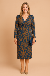 Elegant purple co-ord set featuring a twist-front long-sleeve blouse and matching high-waist midi skirt with intricate burnt-orange paisley pattern.