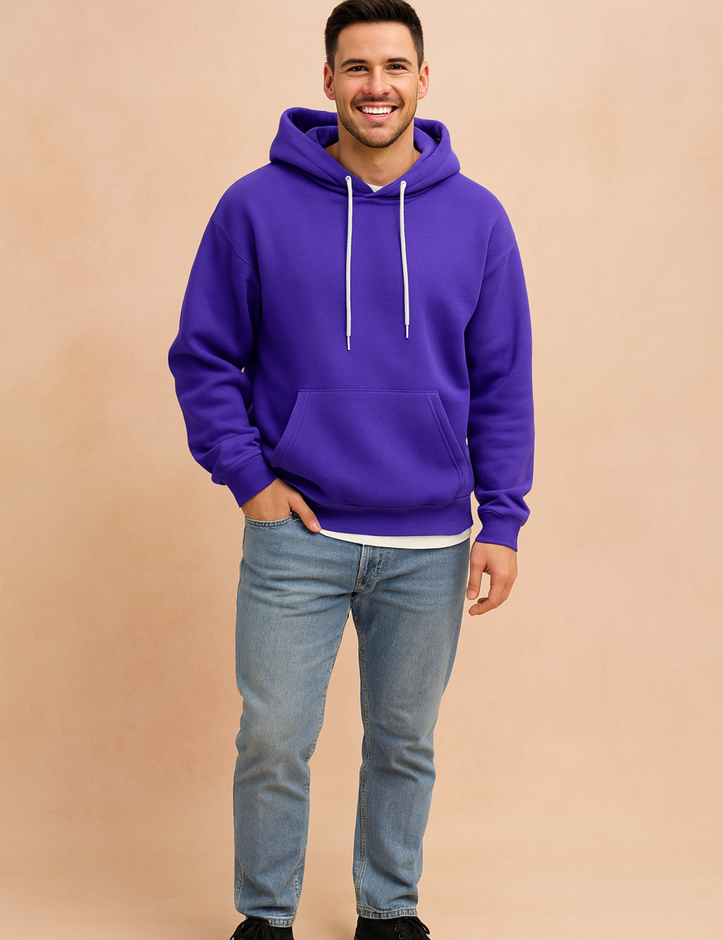 Men’s purple pullover hoodie with white drawstrings, front kangaroo pocket, ribbed cuffs, and hem, styled with light blue jeans for a casual streetwear look.