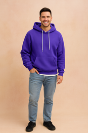 Men’s purple pullover hoodie with white drawstrings, front kangaroo pocket, ribbed cuffs, and hem, styled with light blue jeans for a casual streetwear look.