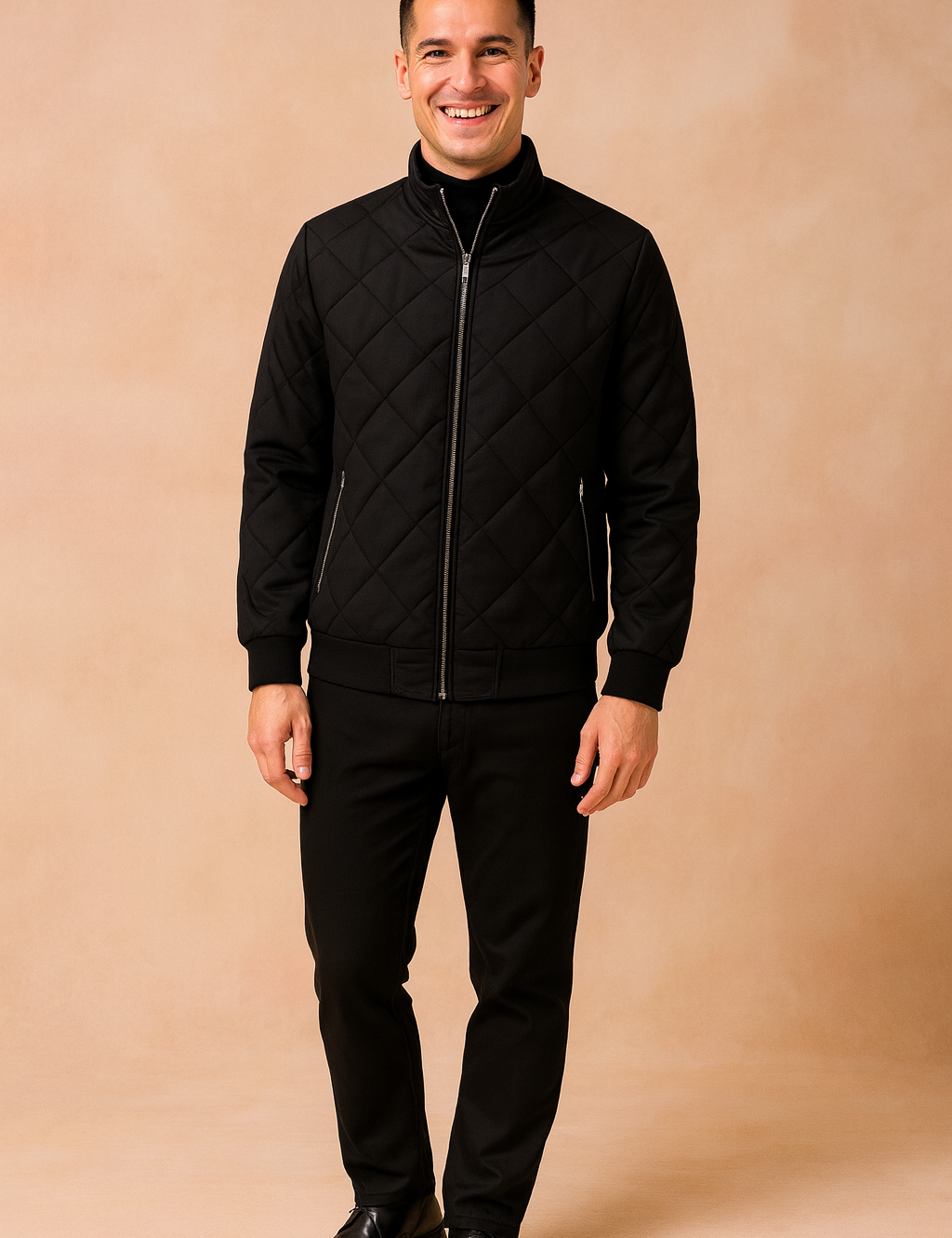 Men’s quilted black bomber jacket with diamond stitching, front zipper closure, and ribbed cuffs paired with slim black pants.