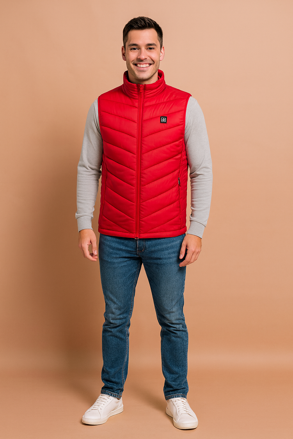 Men’s red heated vest with chevron quilted design, full zip closure, and high collar. Paired with jeans and brown casual shoes for a modern, practical look