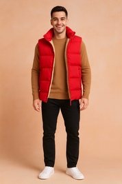 Stylish red padded vest with beige fur lining, paired with a camel sweater, black slim-fit pants, and white sneakers, perfect for casual winter fashion.
