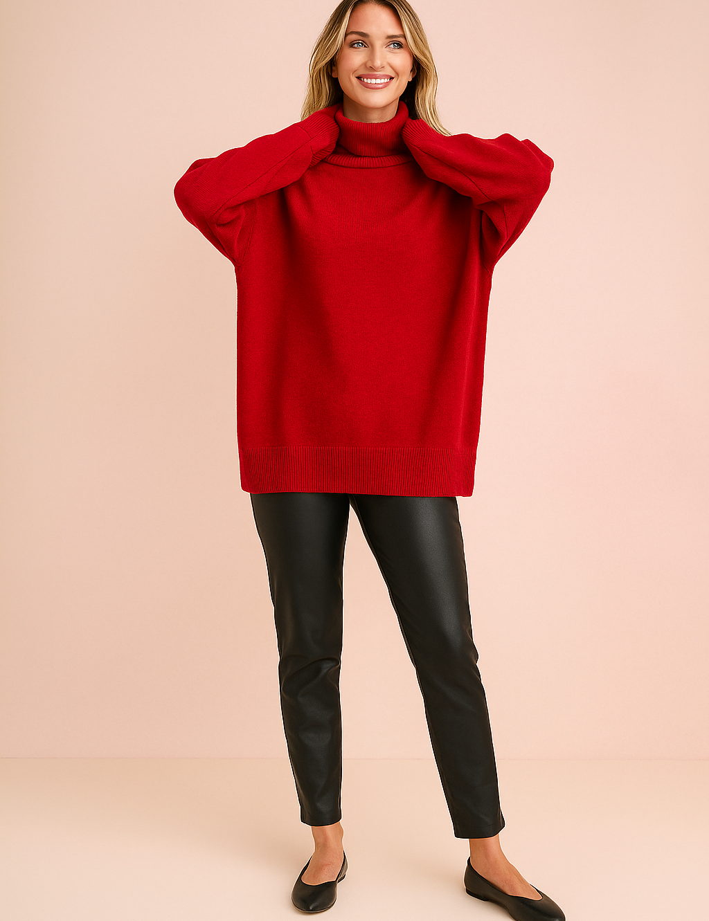 Oversized red turtleneck sweater with ribbed cuffs and hem, styled with black faux leather slim-fit pants and minimalist black flats