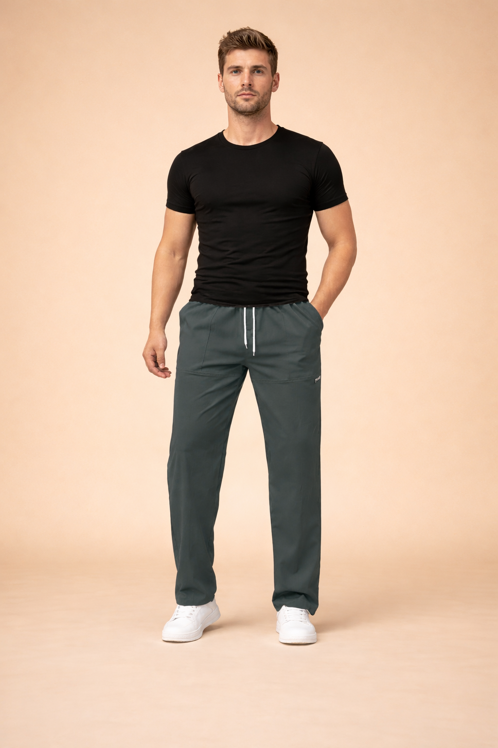 Men’s relaxed-fit drawstring trousers with elastic waistband, straight-leg cut, clean front seam detailing, subtle side logo accent, and minimal sporty-casual silhouette styled with low-profile sneakers.
